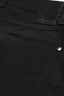 Close-up of black pants with a brand label on the pocket.