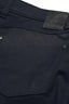 Close-up of dark blue pants with stitching details