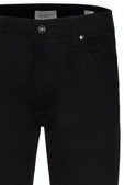 Close-up of black pants with a brand label on a white background