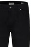 Close-up of black pants with a brand label on a white background